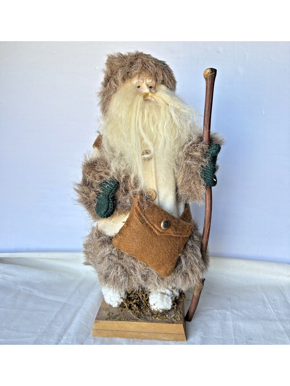 14” Santa Figure Wearing White Outfit with Brown Fur, Sack & Wood Walking Stick